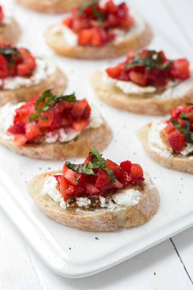 Strawberry Bruschetta is a simple, elegant and impressive appetizer or light lunch option! Pile fresh strawberries on top of crusty bread with goat cheese and drizzle with olive oil and balsamic vinegar.