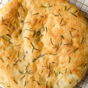 loaf of rosemary focaccia on a cooling rack
