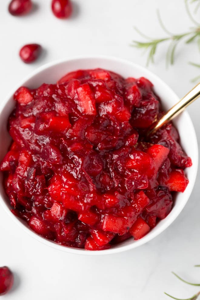 Combine a few simple ingredients in a saucepan to make this homemade apple cranberry sauce with orange and ginger! It's packed with flavor and is paleo and naturally gluten free. #apple #cranberry #sauce #orange #ginger #recipe #healthy #paleo