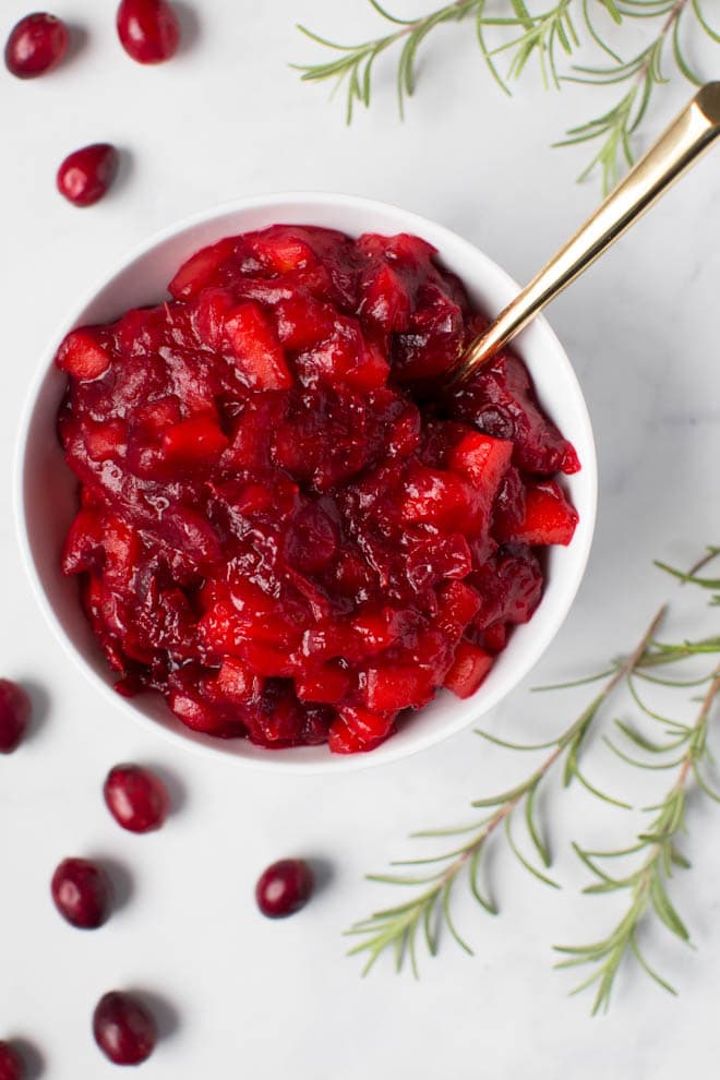Combine a few simple ingredients in a saucepan to make this homemade apple cranberry sauce with orange and ginger! It's packed with flavor and is paleo and naturally gluten free. #apple #cranberry #sauce #orange #ginger #recipe