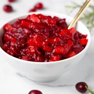 Combine a few simple ingredients in a saucepan to make this homemade apple cranberry sauce with orange and ginger! It's packed with flavor and is paleo and naturally gluten free. #apple #cranberry #sauce #orange #ginger #recipe #healthy #thanksgiving #sidedish #homemade