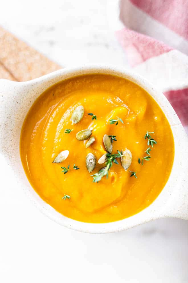 Squash soup in a bowl with pepitas