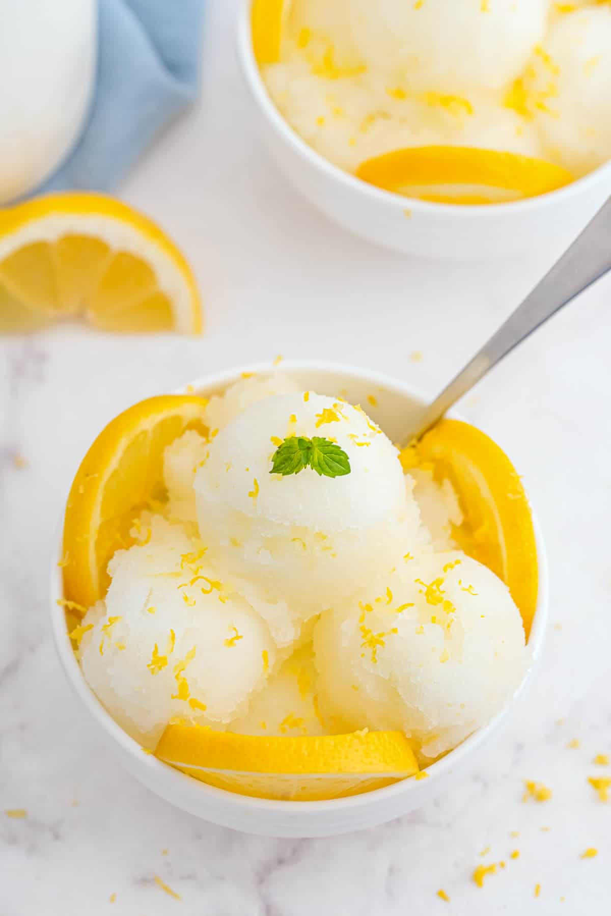 a bowl with three scoops of lemon sorbet
