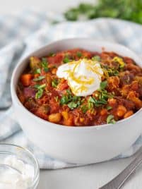 vegetarian bean chili in a bowl with sour cream on top