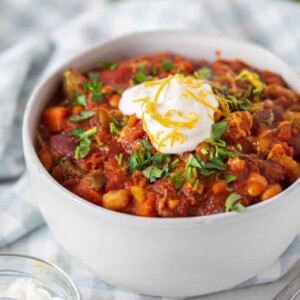 vegetarian bean chili in a bowl with sour cream on top