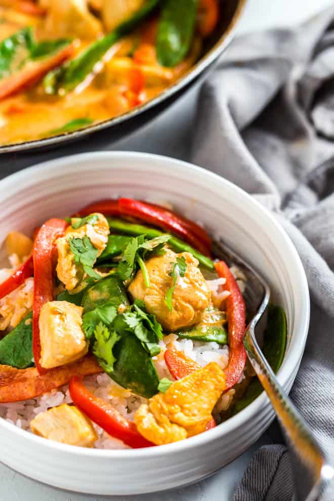 A bowl with rice and coconut chicken curry.