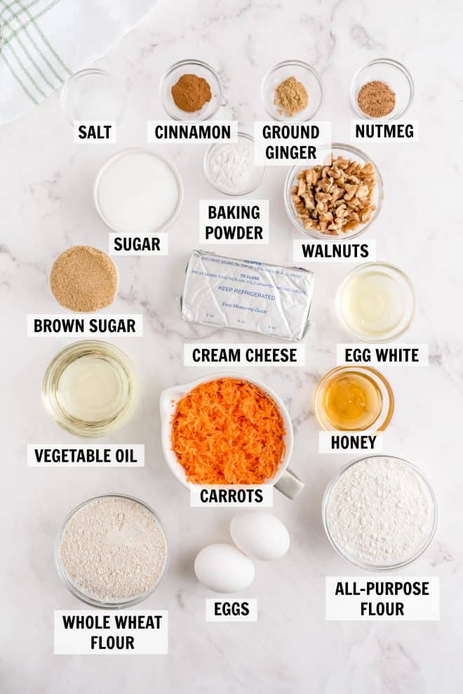 ingredients for carrot loaf on a white backdrop