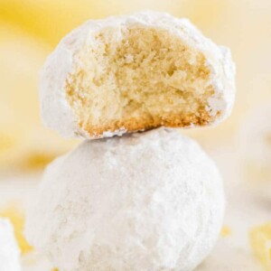 a tea cookie with a bite taken out of it sitting on top of another cookie