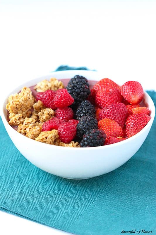 A large acai bowl with fresh berries and granola topping.