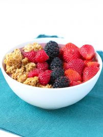 A acai bowl with strawberries, blackberries, raspberries and granola.