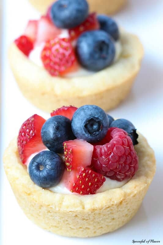 Triple Berry Lemon Cookie Cups - fresh lemon cream and berries sits on top of a delectable lemon sugar cookie crust! Great way to use up your summer berries!