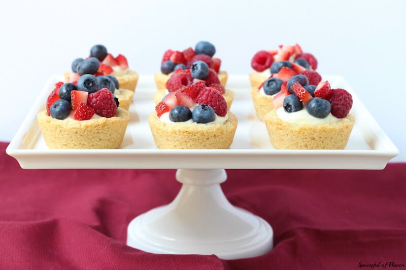 Triple Berry Lemon Cookie Cups - fresh lemon cream and berries sits on top of a delectable lemon sugar cookie crust! The perfect little dessert!