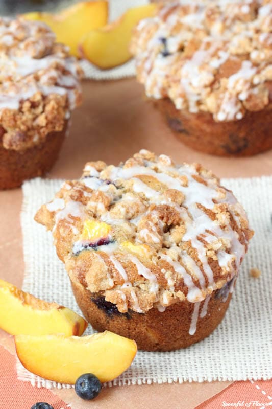 Blueberry Peach Cobbler Muffins - with the best crumble topping! Jumbo sized and perfect for sharing! #muffins