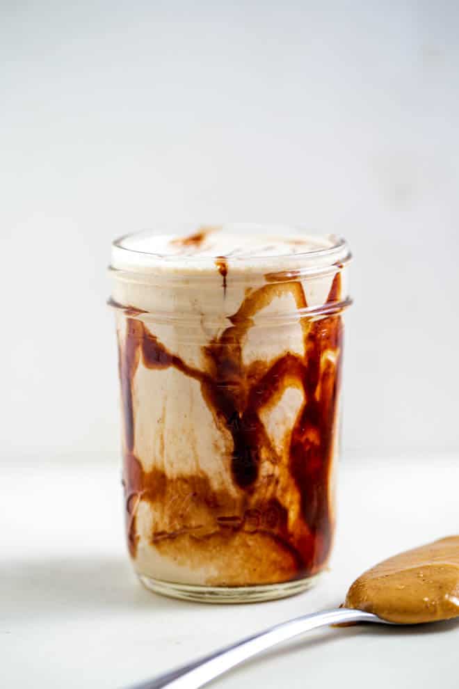 Chocolate peanut butter banana smoothie is a glass mug.