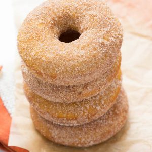 a stack of four baked pumpkin donuts