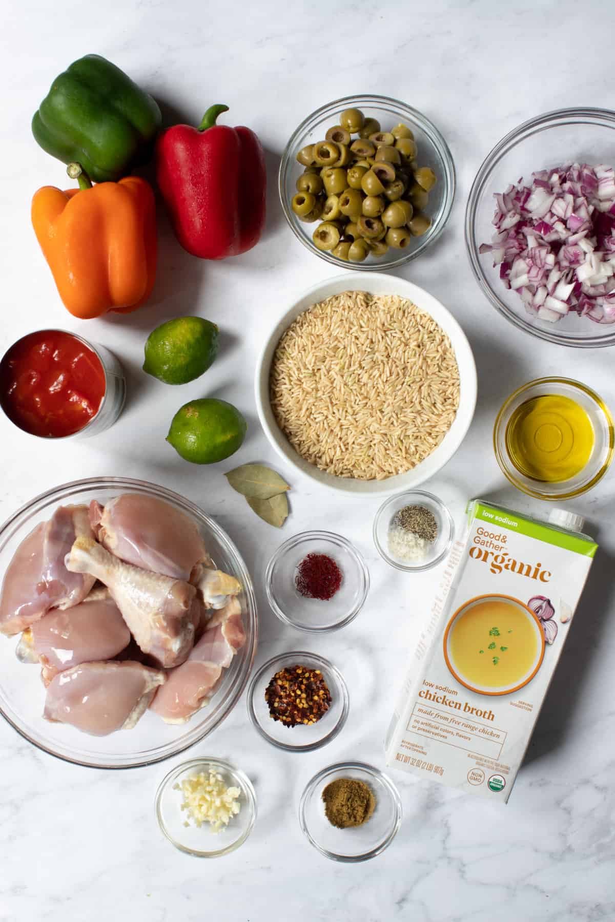 ingredients for spanish chicken and rice on a countertop