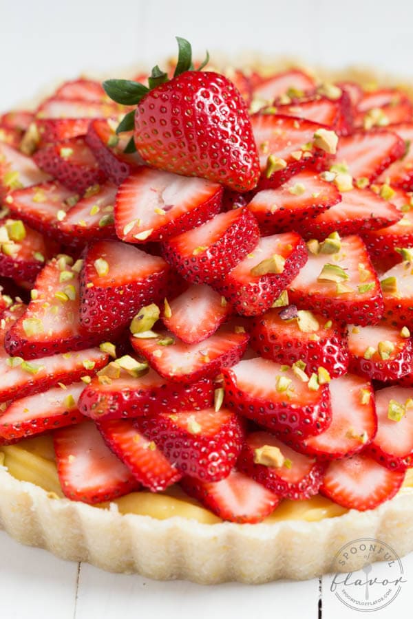 Strawberry Pistachio Cardamom Tart is made with a lemon coconut crust, cardamom pastry cream, fresh strawberries and pistachios! It is gluten free and dairy free too!