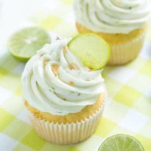 Coconut Cupcakes are stuffed with coconut filling and topped with key lime buttercream frosting! These cupcakes are too good to resist!