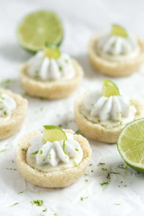 No Bake Mini Key Lime Pies - a layer of crust is filled with key lime filling and topped with whipped coconut cream! These little bites pies are gluten free, vegan, paleo and healthy!