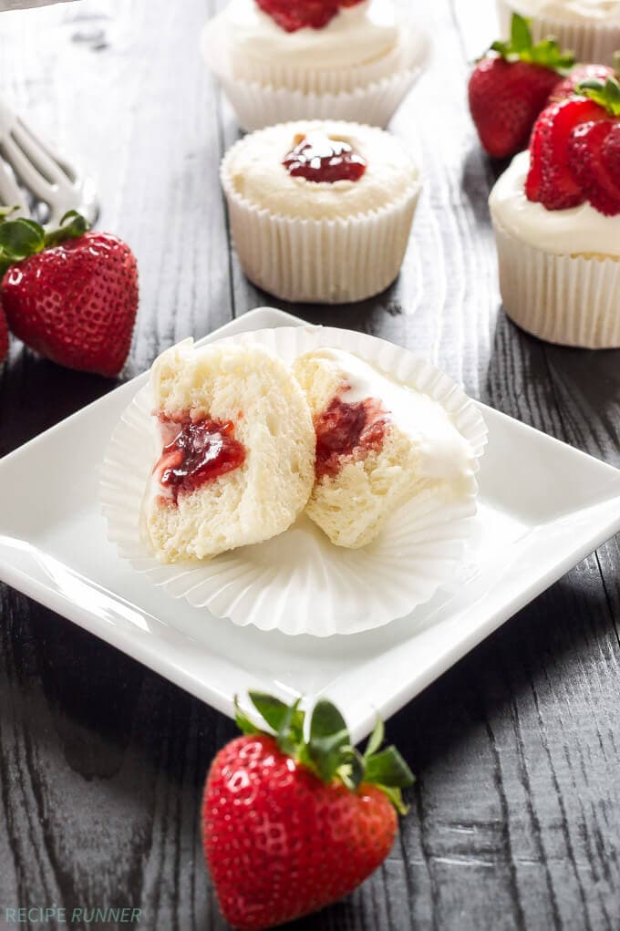 one angel food cupcake cut in half with the strawberry filling