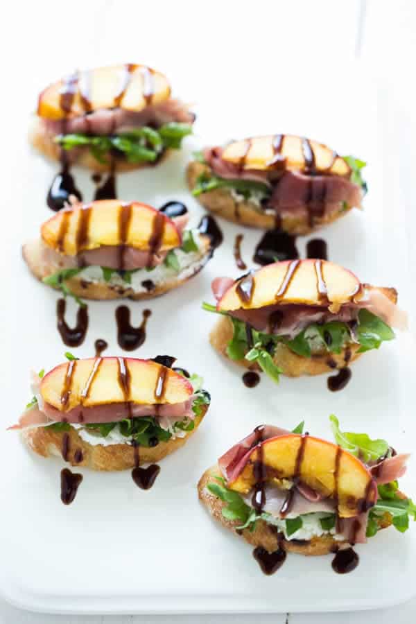 Grilled Peach Crostini with Arugula, Prosciutto and Goat Cheese is the perfect light summer snack, appetizer or lunch!