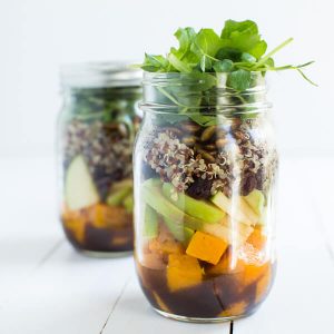 Fall Mason Jar Salad with Maple Balsamic Dressing includes roasted butternut squash, apples, dried cranberries, quinoa, toasted pumpkin seeds, and fresh greens!