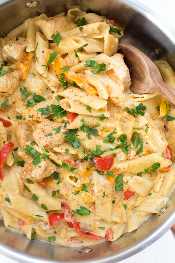 A large skillet with cajun chicken pasta