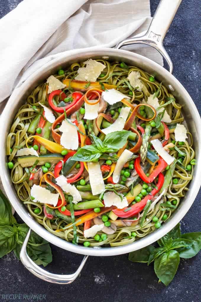 A big pot of primavera pasta with spinach fettucine, bell peppers, asparagus, zucchini, peas and fresh parmesan. 