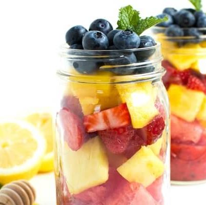 Mason Jar Fruit Salad with Strawberry Mint Dressing is made with the freshest flavors piled high in a mason jar. Kids and adults will love it!