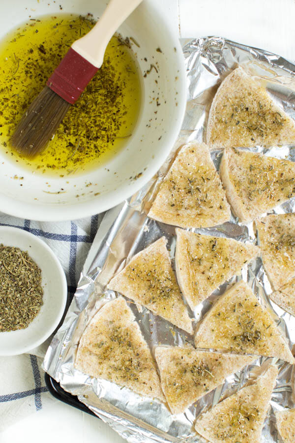 Baked Seasoned Pita Chips are made with only three ingredients and taste better than anything you can buy at the store. Serve with hummus, dip and more!