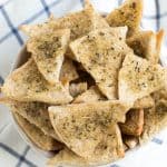 A large bowl of baked seasoned pita chips.