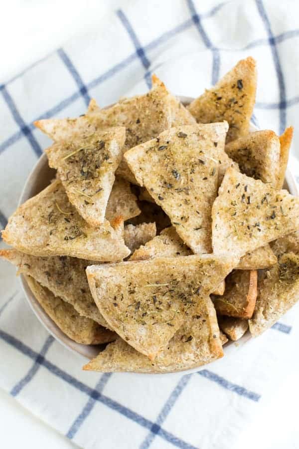 Baked Seasoned Pita Chips are made with only three ingredients and taste better than anything you can buy at the store. Serve with hummus, dip and more!