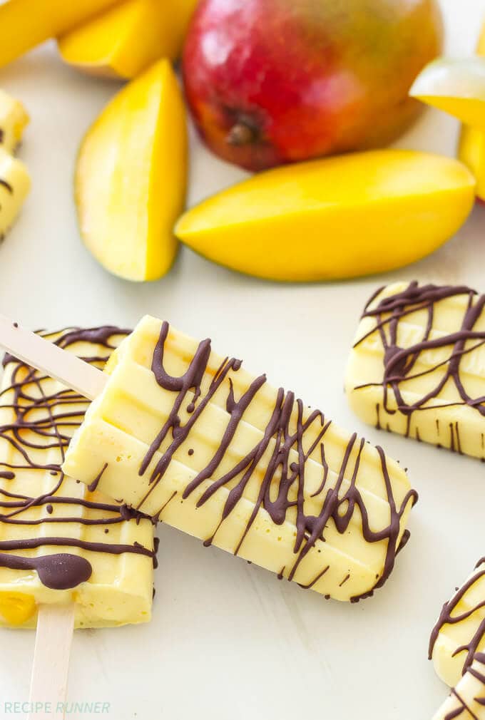 Chocolate Drizzled Mango Yogurt Pops | A sweet, frozen treat to cool off with on a hot day! Made with healthy ingredients they’re perfect for a snack, dessert or even breakfast!