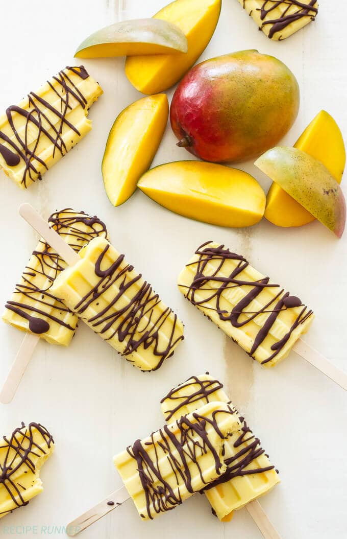 Chocolate Drizzled Mango Yogurt Pops | A sweet, frozen treat to cool off with on a hot day! Made with healthy ingredients they’re perfect for a snack, dessert or even breakfast!