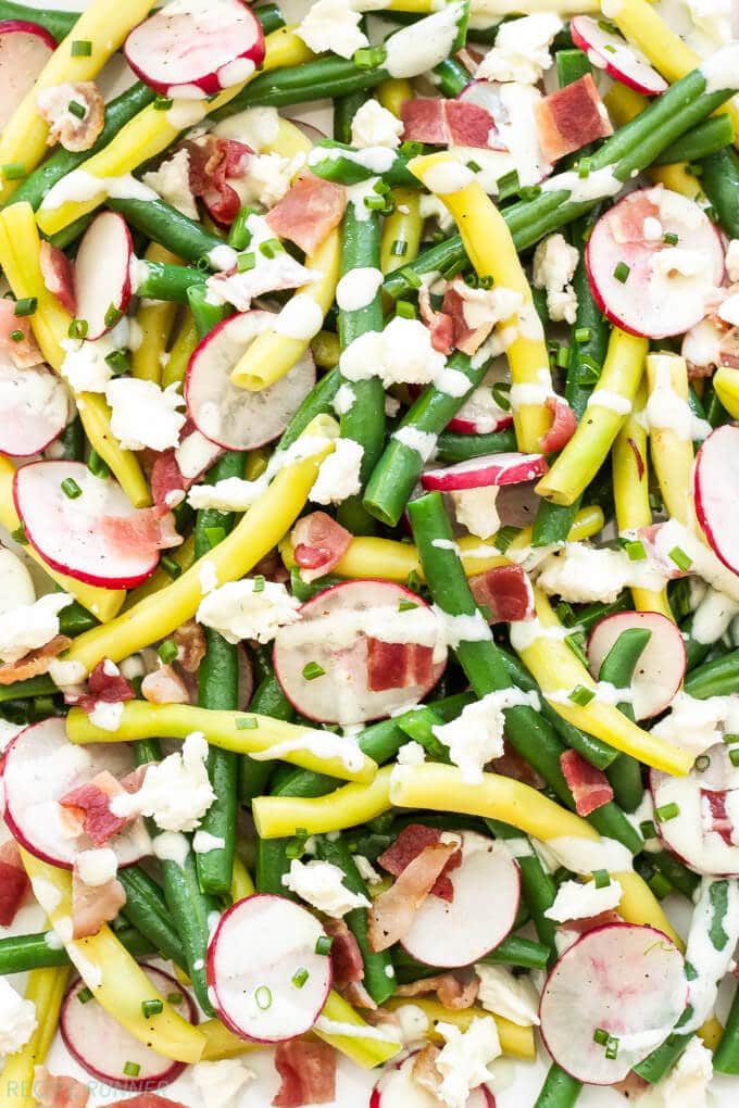 green beans, radishes, bacon and creamy feta dressing on a plate