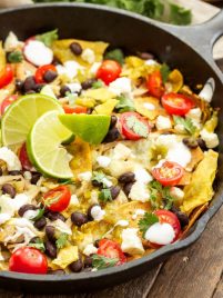 a skillet filled with easy chicken chilaquiles and toppings