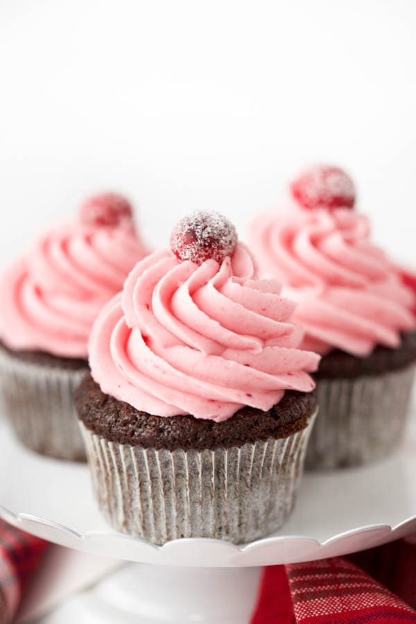 Gingerbread cupcakes with cranberry buttercream frosting combine two of your favorite holiday flavors in one sweet treat that is sure to impress!