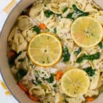 a pot filled with cooked chicken tortellini soup with spinach