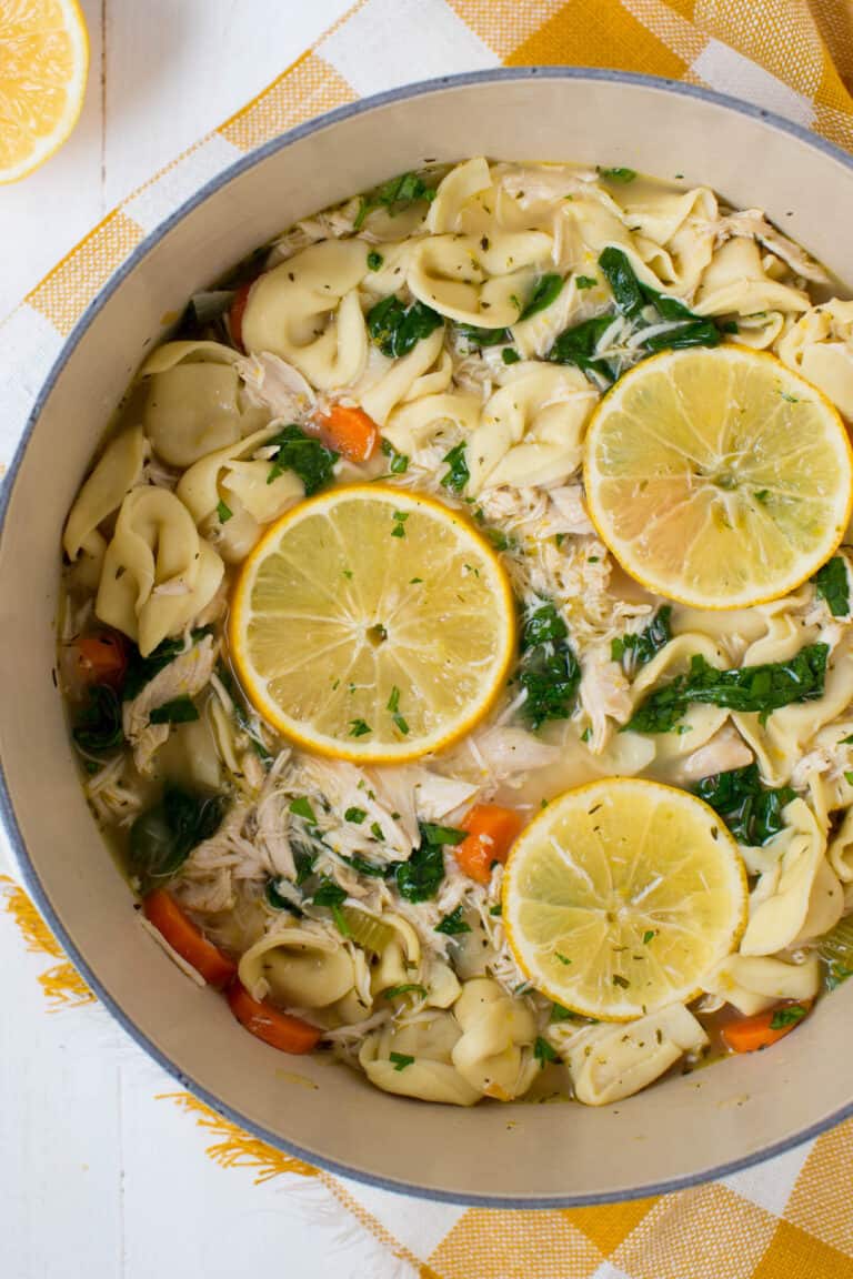 a pot filled with cooked chicken tortellini soup with spinach