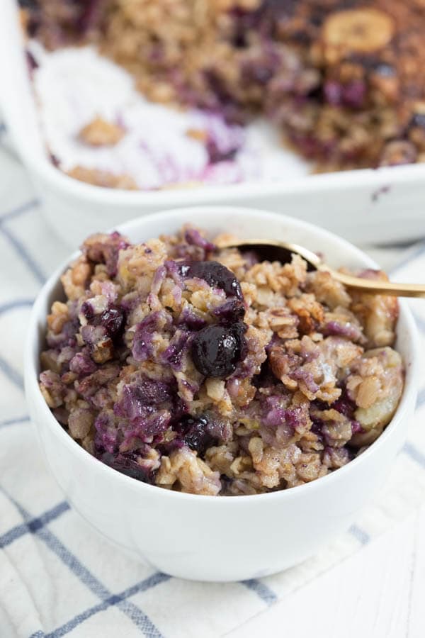 Banana Berry Crunch Baked Oatmeal is a simple, healthy and delicious way to start your day! This easy recipe is made with coconut milk, rolled oats, fresh bananas, berries and maple syrup. 