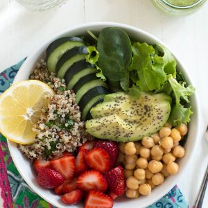 Nourish yourself with a berry green Buddha bowl with lemon avocado kale mint dressing!