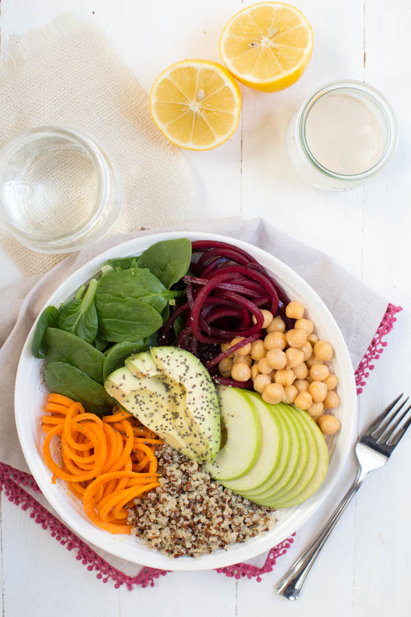 Harvest Buddha Bowl with Lemon Tahini Dressing is made with fresh spiralized beet and sweet potato noodles, spiralized apple, chickpeas, spinach and more! Pack this bowl for lunch to fuel up for the day.