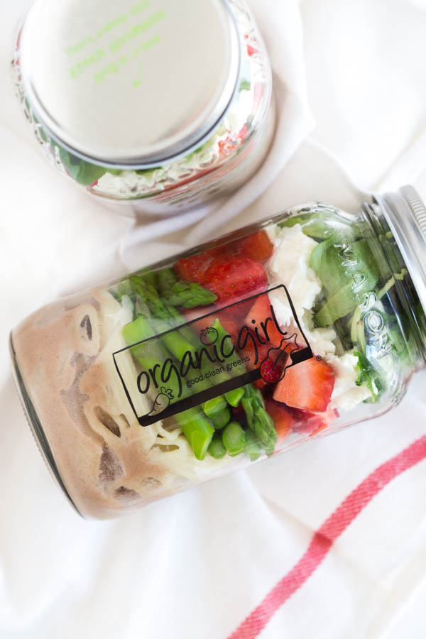Six ingredients are layered in a mason jar to create a fresh and flavorful Spring Green Mason Jar Salad with Strawberries! Pack the mason jar for on-the-go or enjoy an easy lunch at home.