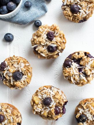 baked oatmeal cups with blueberries sitting on a white tabletop