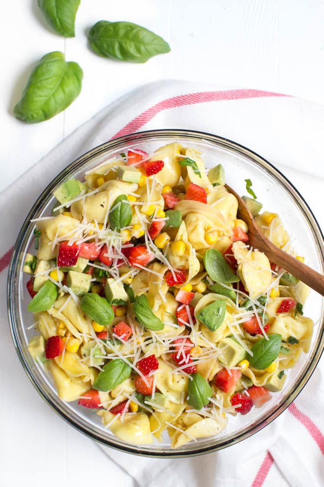 Strawberry, Corn and Avocado Tortellini Salad is a refreshing summer salad made with strawberries, corn, avocado, basil, Parmesan cheese and a simple balsamic dressing! 
