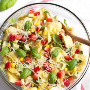 Strawberry, Corn and Avocado Tortellini Salad is a refreshing summer salad made with strawberries, corn, avocado, basil, Parmesan cheese and a simple balsamic dressing!