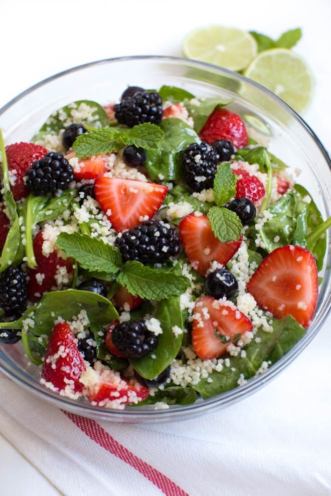 Triple Berry Couscous Salad with Honey Lime Mint Dressing combines couscous with fresh spinach, strawberries, blueberries and blackberries. Drizzle the homemade honey lime mint dressing over the salad to create a light and flavorful addition to any meal!