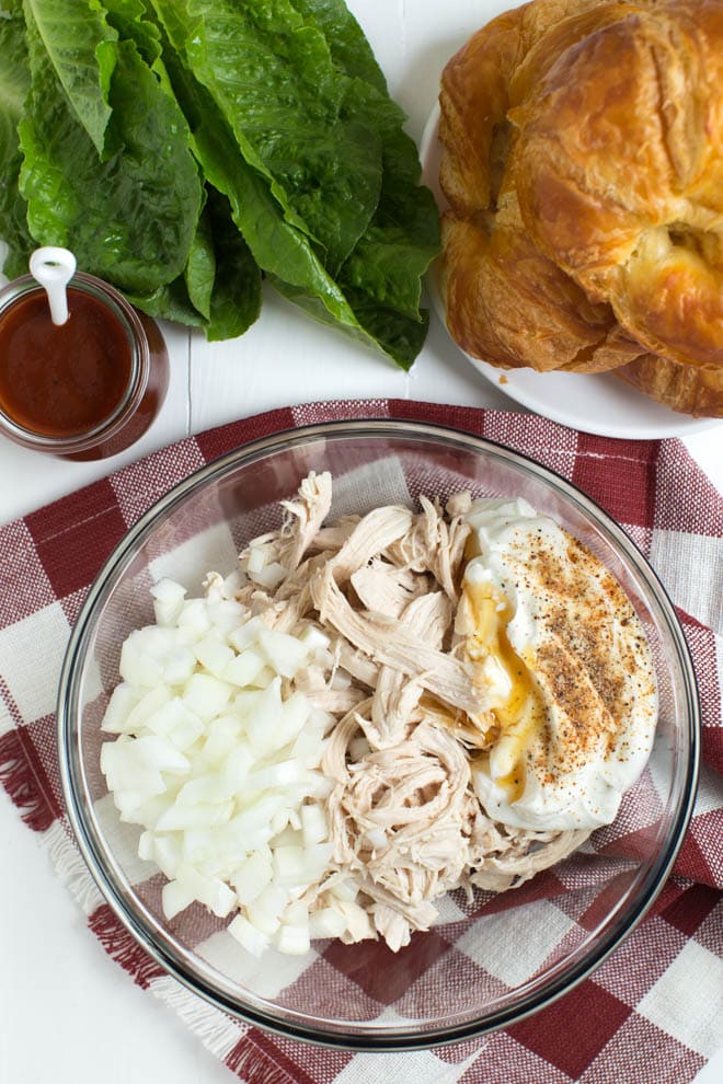 Light and Creamy Barbecue Chicken Salad is made with Greek yogurt, barbecue sauce, yellow onion and a few simple seasonings to create a chicken salad that you will want to eat all year long!