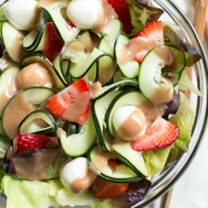 Strawberry, Cucumber and Mozzarella Salad is made with only five ingredients including a flavorful pomegranate balsamic dressing! Enjoy as a side or main dish for summer or all year long.