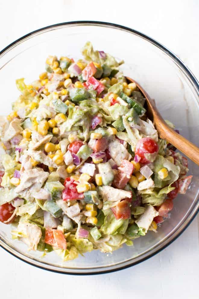Creamy Chicken Fajita Chopped Salad comes together in less than 15 minutes! It is packed with fresh veggies, butter lettuce, creamy white cheddar dressing and fajita seasoning. 
